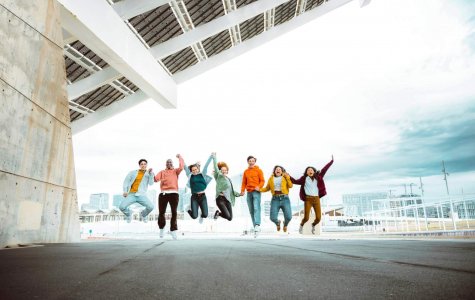 Happy,Group,Of,Young,People,Jumping,On,City,Street,-